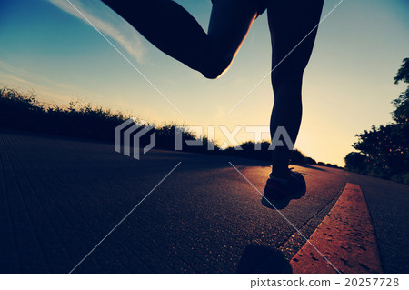 young fitness woman running on sunrise seaside trail young fitness woman running on sunrise seaside trail 20257728