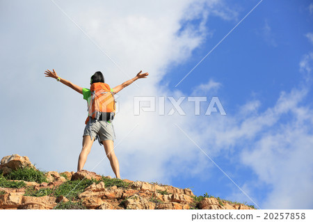 young woman backpacker climbing to mountain peak young woman backpacker climbing to mountain peak 20257858
