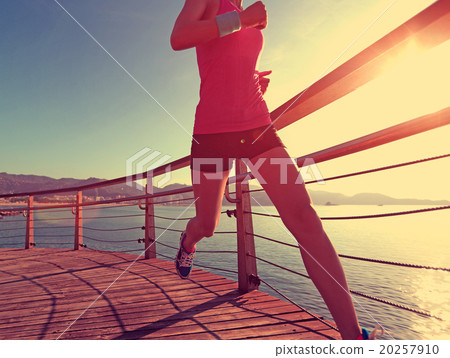 young fitness woman runner running at seaside boardwalk 20257910