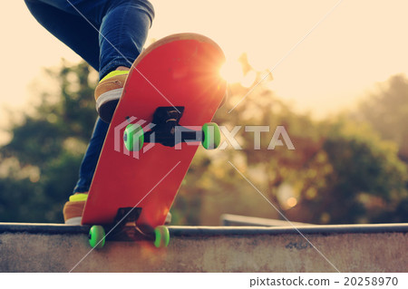 young woman skateboarder skateboarding at sunrise skatepark 20258970