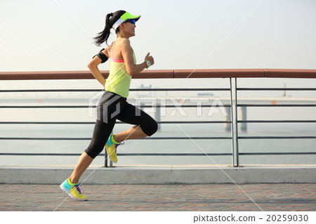 young fitness woman runner running on seaside bridge 20259030