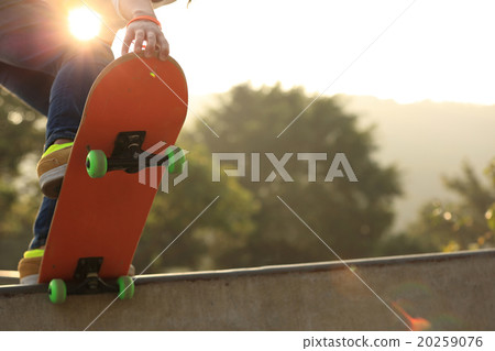 young woman skateboarder skateboarding at sunrise skatepark young woman skateboarder skateboarding at sunrise skatepark 20259076