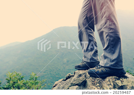young woman hiker hiking at mountain peak young woman hiker hiking at mountain peak 20259487