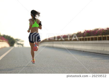 young woman runner running on city bridge road young woman runner running on city bridge road 20259512