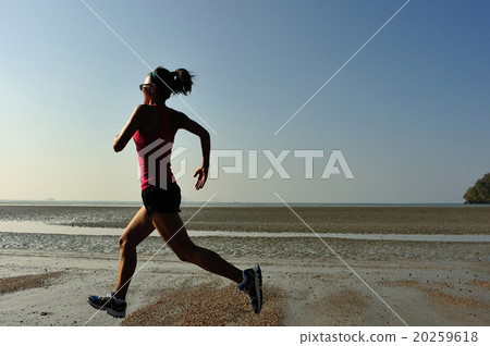 young fitness woman runner running at sunrise beach 20259618