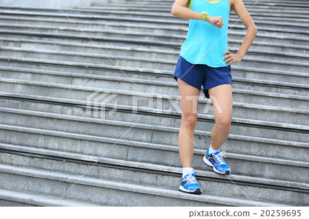 young fitness woman runner looking at her sports watch young fitness woman runner looking at her sports watch 20259695