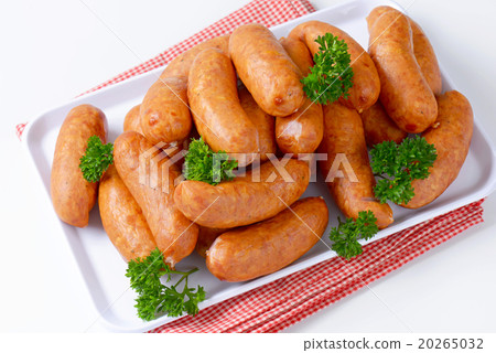 Pile of Polish sausages on plate 20265032