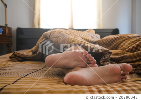 a man sleeping on bed in the morning a man sleeping on bed in the morning 20290345