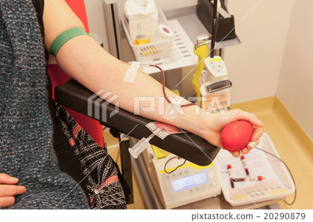 Donor in an armchair donates blood 20290879