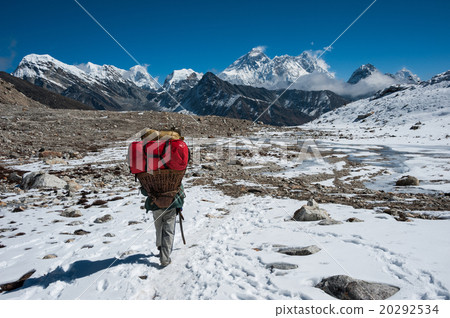 Mt.Everest and a porter at Renjo mountain pass Mt.Everest and a porter at Renjo mountain pass 20292534
