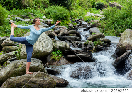 Woman doing yoga asana outdoors at waterfall Woman doing yoga asana outdoors at waterfall 20292751
