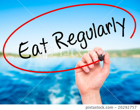 Man Hand writing Eat Regularly with black marker 20292757