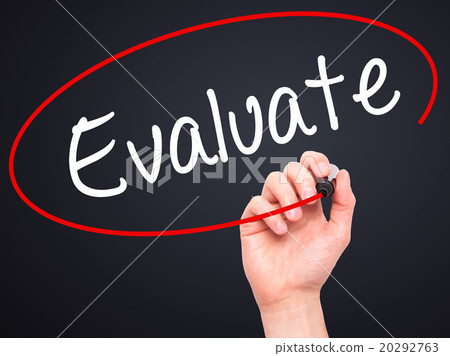 Man Hand writing Evaluate  with black marker 20292763