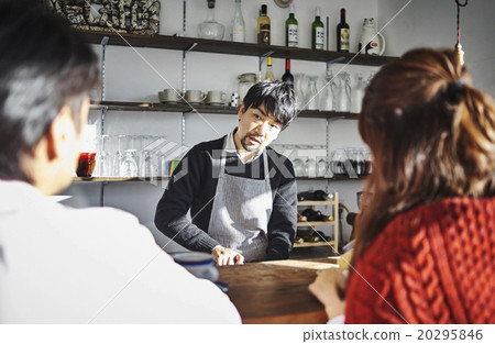 Male and female conversing at the cafe counter Male and female conversing at the cafe counter 20295846