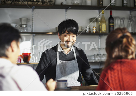 Male and female conversing at the cafe counter 20295965
