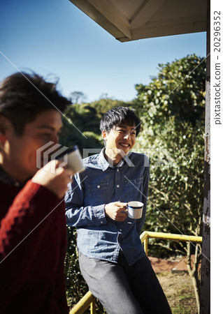 A man relaxing with a cup 20296352