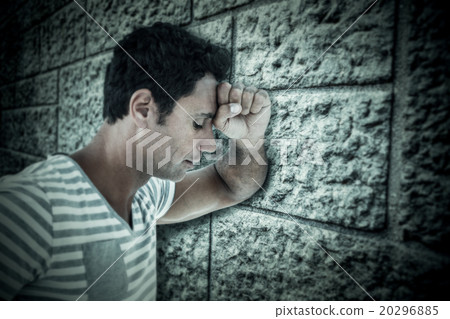 Composite image of upset man leaning on white background Composite image of upset man leaning on white background 20296885