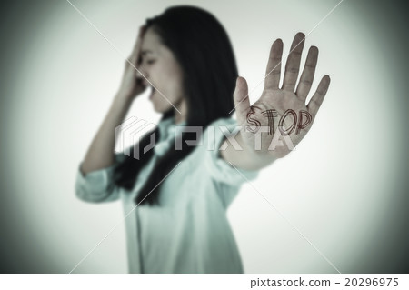Composite image of irritated woman showing her hand Composite image of irritated woman showing her hand 20296975