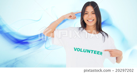 Composite image of smiling woman pointing to her volunteer tshir 20297202