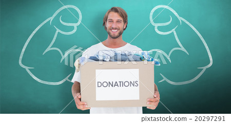 Composite image of happy man carrying donation box Composite image of happy man carrying donation box 20297291