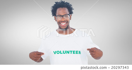 Composite image of handsome man pointing to his volunteer tshirt 20297343