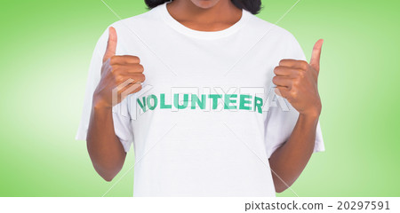 Composite image of woman wearing volunteer tshirt and giving thu 20297591