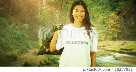 Composite image of team of volunteers picking up litter in park 20297831