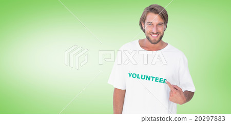 Composite image of smiling man pointing to his volunteer tshirt 20297883