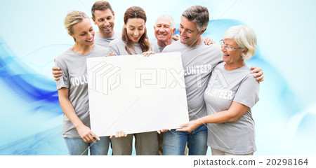 Composite image of happy volunteer family holding a blank 20298164
