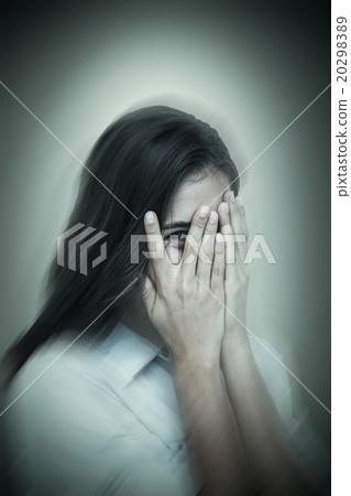 Composite image of portrait of woman peeking through fingers Composite image of portrait of woman peeking through fingers 20298389