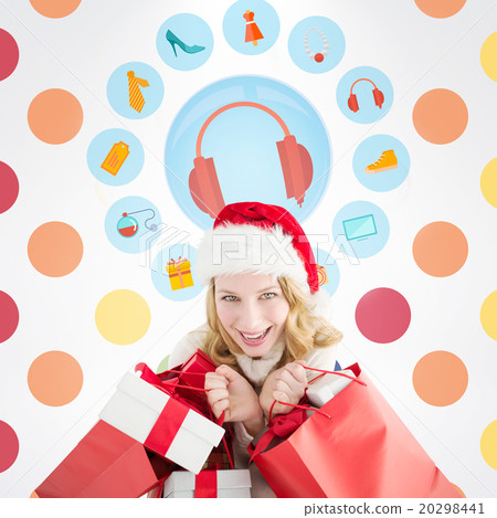 Composite image of girl in winter fashion holding presents and s 20298441