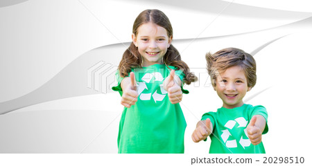 Composite image of happy siblings in green with thumbs up 20298510