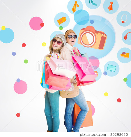 Composite image of beautiful women holding shopping bags looking Composite image of beautiful women holding shopping bags looking 20298650