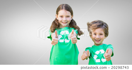 Composite image of happy siblings in green with thumbs up 20298743