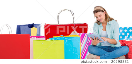 Composite image of pretty hipster using tablet pc Composite image of pretty hipster using tablet pc 20298881
