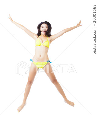 Attractive young woman in bikini jumping 20301565