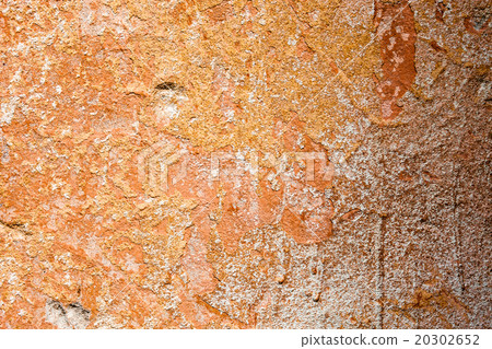 Concrete surface with the remains of orange paint  20302652