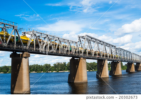 Railroad bridge with freight train Railroad bridge with freight train 20302673