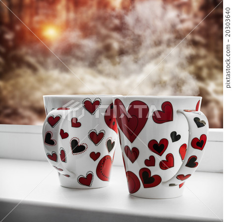 cups with hearts stands on a window sill cups with hearts stands on a window sill 20303640