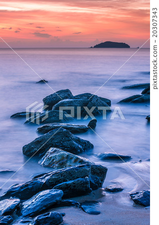 Long exposure of rocky shore over sunset in Long exposure of rocky shore over sunset in 20307343