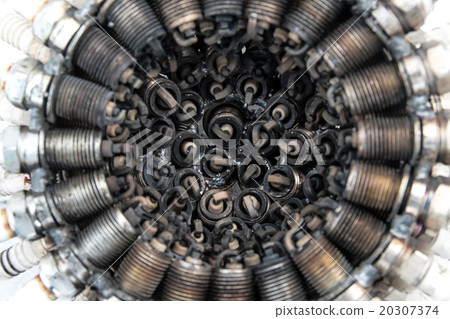 Old spark plugs arranged in a circle at a shallow  20307374