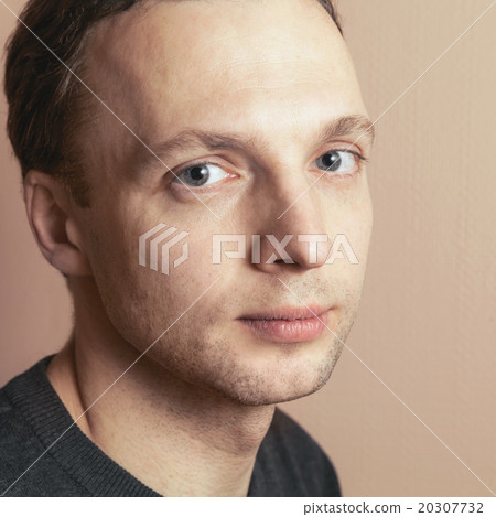 Young positive handsome man studio portrait 20307732