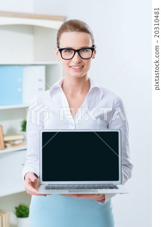 Positive woman holding her laptop  20310481
