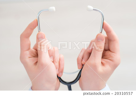 Professional pediatrician holding stethoscope Professional pediatrician holding stethoscope 20310557