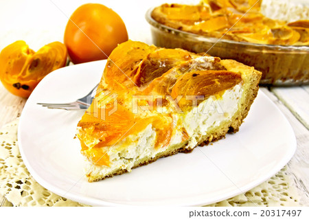 Pie with curd and persimmons in plate on napkin 20317497