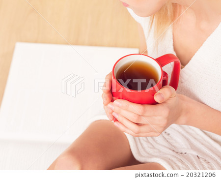 Lady with a cup of tea indoors 20321206