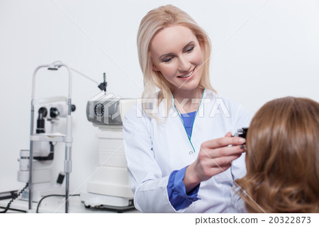 Cheerful young oculist is working with her patient 20322873