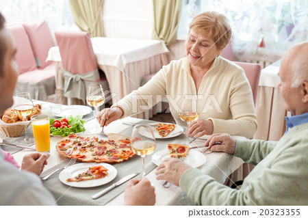 Pretty friendly family is dining in restaurant Pretty friendly family is dining in restaurant 20323355
