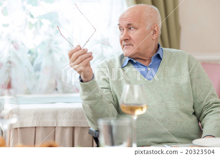 Cheerful old grandfather is resting in restaurant Cheerful old grandfather is resting in restaurant 20323504
