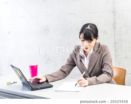 woman working on a computer woman working on a computer 20325438
